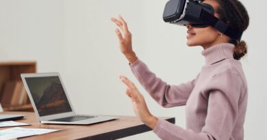 Employees using virtual reality headsets and augmented reality glasses in a modern workplace.